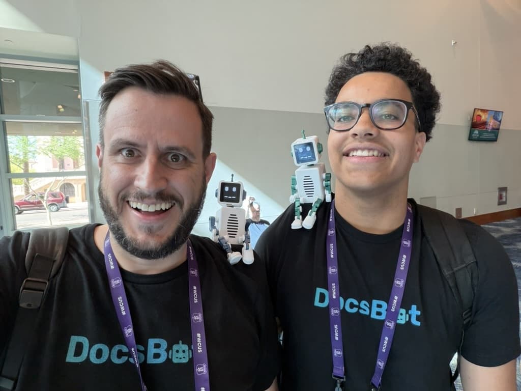 Aaron and a conference attendee wearing DocsBot Robot prototypes